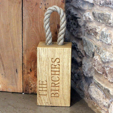 personalised oak door stop with rope handle.